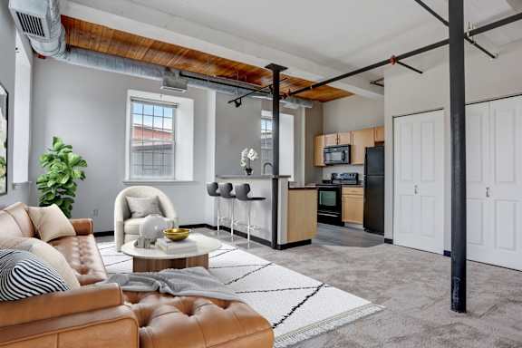 an open kitchen and living room with a couch and a table