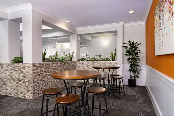 A modern dining area with a round table and chairs.