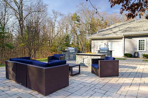 A patio with a couch and a chair.