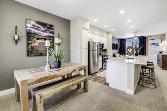 The dining room with a dining table and chairs and a view of the kitchen at Desert Club. 