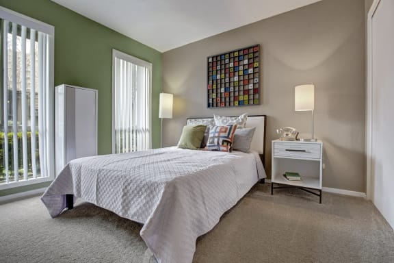 A bedroom with a queen-size bed, closet, and nightstands at Capitol Towers - Towers and Villas. 