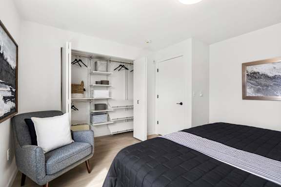 a bedroom with a bed and a chair