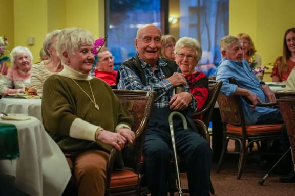 a group of elderly people sitting at a table at Winding Commons Senior Living, Carmichael