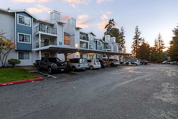 an apartment building with cars parked in front of it