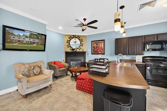 A living room with a couch, chair, and television.