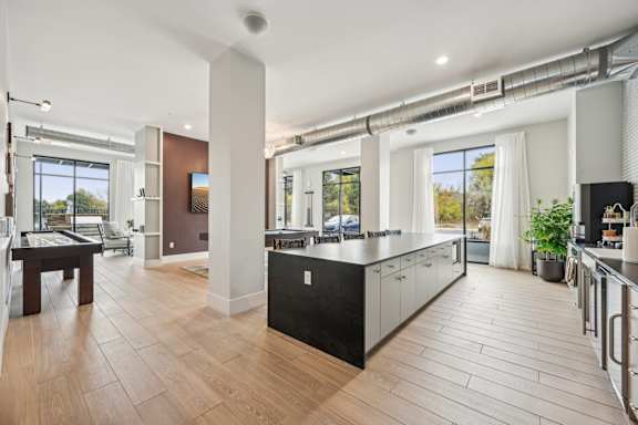 a kitchen with a large island in the middle of a room at The Quarry Luxury Apartment Homes, Fort Collins, CO, 80526