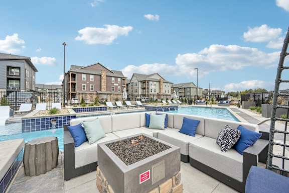 outdoor seating area with pool and buildings in the background at The Quarry Luxury Apartment Homes, Fort Collins, CO, 80526