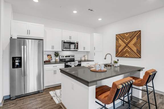 a kitchen with a large island and a stainless steel refrigerator at Notch66, Longmont, Colorado