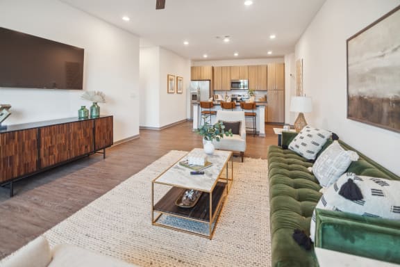 a living room with a green couch and a table  at Palm Grove, Ellenton, FL, 34222