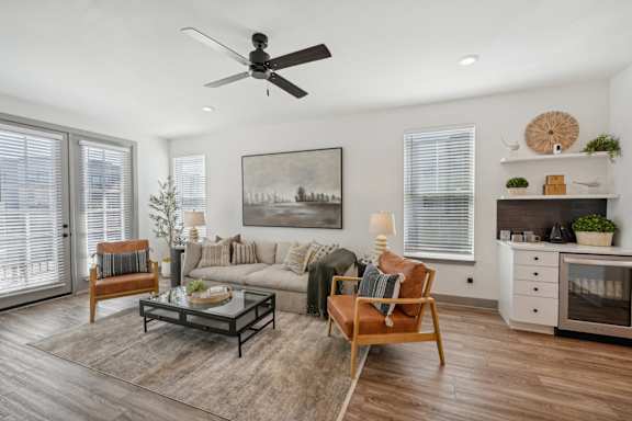 a living room with a couch and a ceiling fan at CityPlace, Woodbury, MN 55125