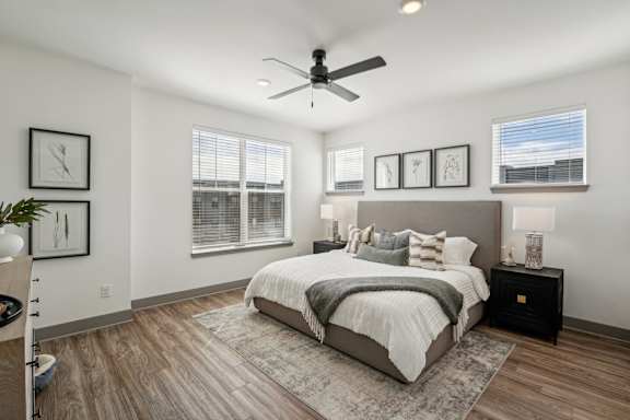 a bedroom with a bed and a ceiling fan at CityPlace, Woodbury, MN 55125