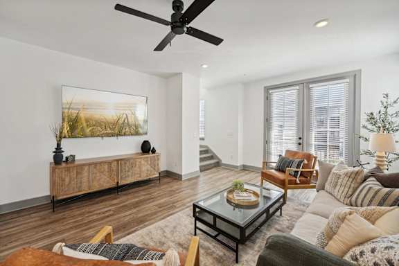 a living room with a ceiling fan and a couch