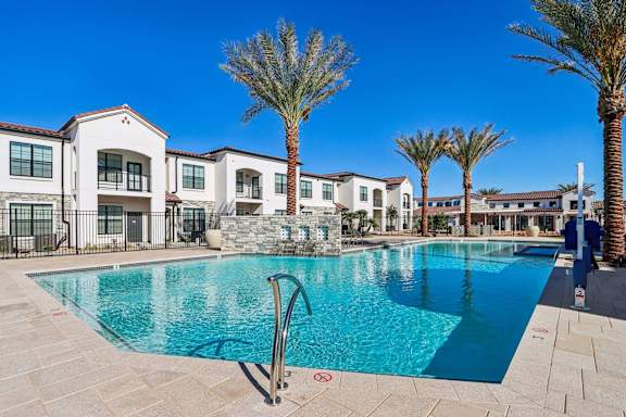 a swimming pool with apartments in the background at Stella Luxury Apartment Homes, San Tan Valley, AZ, 85143