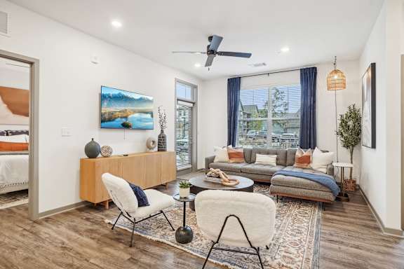 a living room with a couch and a chair and a ceiling fan at Notch66, Longmont, Colorado