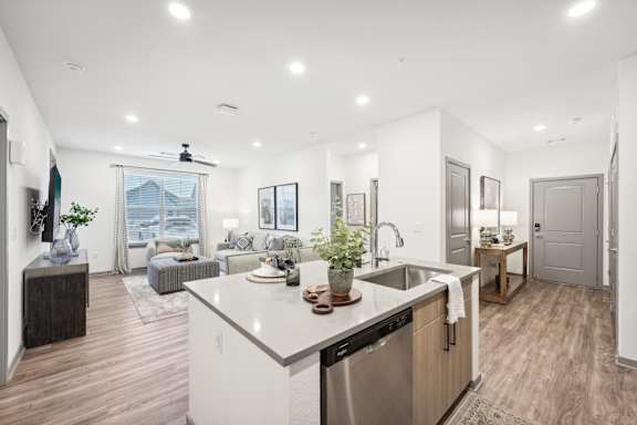 a kitchen with a large island and a living room at The Garrison Luxury Apartment Homes, Colorado, 80817