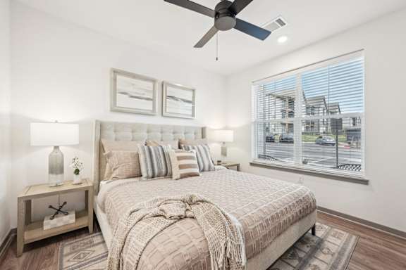 a bedroom with a bed and a ceiling fan at The Garrison Luxury Apartment Homes, Colorado, 80817