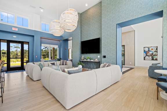Lounge Area With TV at The Quinn Luxury Apartments, Pensacola, FL