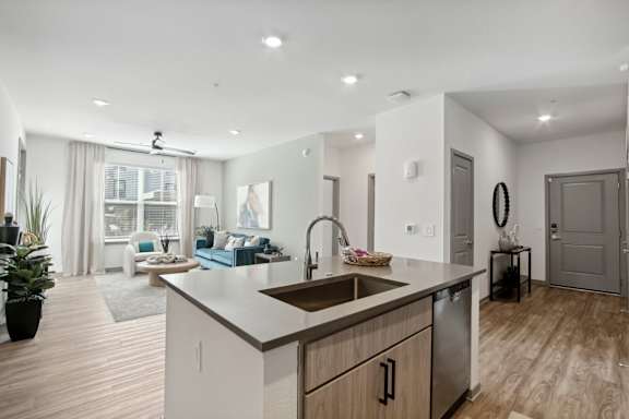 an open kitchen and living room with a large window and a sink at The Maddox Luxury Apartment Homes, Arizona, 85326