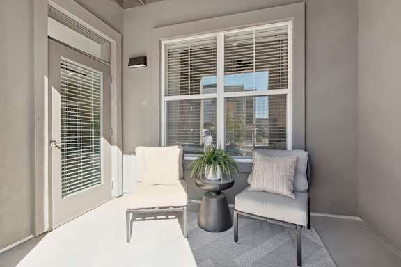 a living room with a couch and a table and a window at The Maddox Luxury Apartment Homes, Arizona, 85326