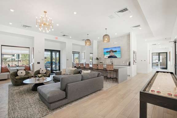 a living room with couches and chairs and a dining room table at The Maddox Luxury Apartment Homes, Arizona, 85326