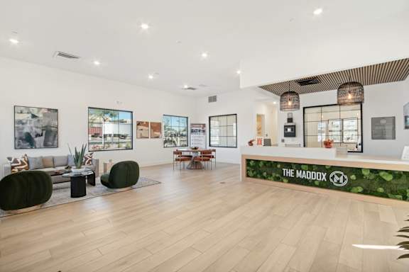 the lobby of the madison hotel with a reception desk and plants at The Maddox Luxury Apartment Homes, Arizona, 85326
