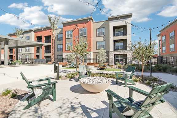 an architectural rendering of an apartment building with a courtyard with tables and chairs at The Maddox Luxury Apartment Homes, Arizona, 85326
