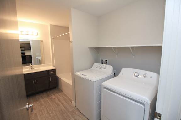 A bathroom with a washer and dryer in it.