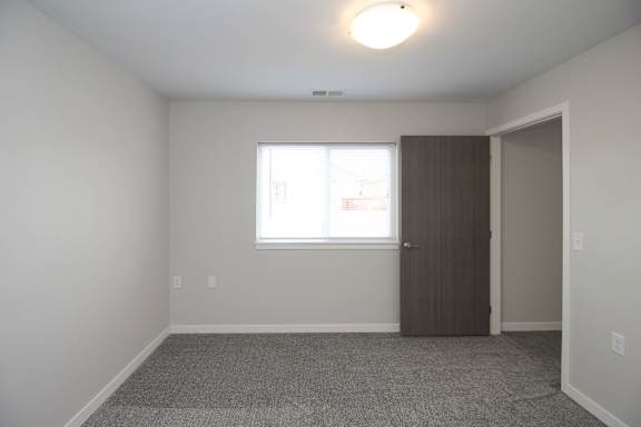 A room with a window and a door.