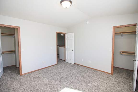 A room with white walls and a carpeted floor.