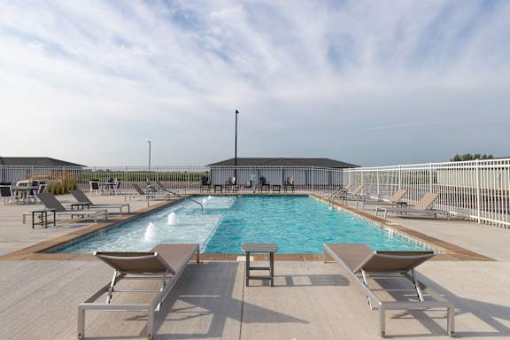 Outdoor pool with lounge seating at City’s Edge.
