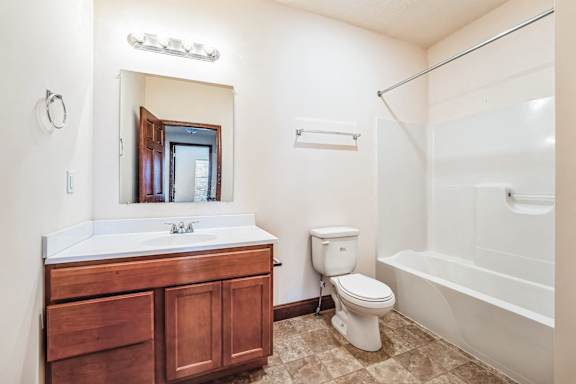 a bathroom with a sink toilet and a bath tub