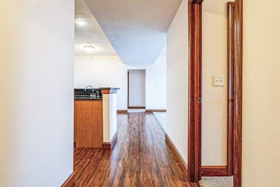 the view from the living room into the kitchen and dining room