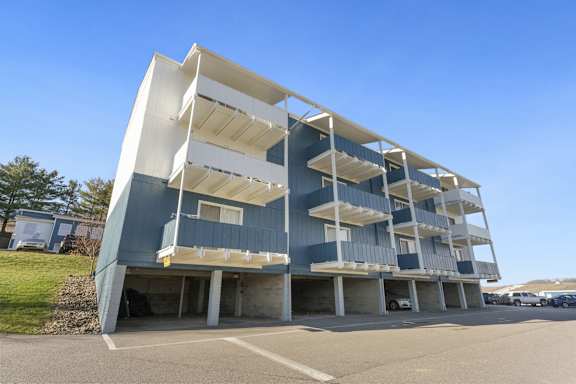 a modern building with balconies in a parking lot