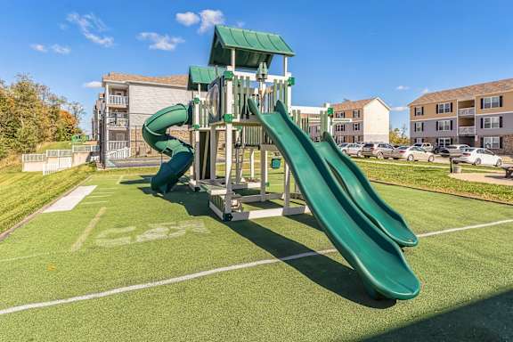 a playground with a slide in a park