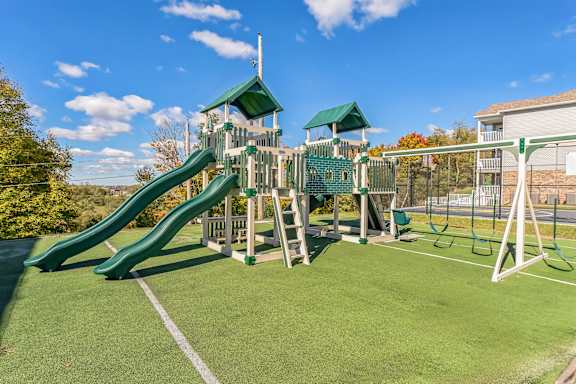 a playground with a jungle gym and a slide