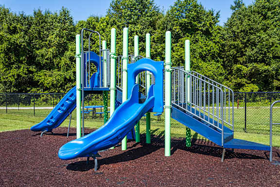 a playground with two slides and a monkey bars