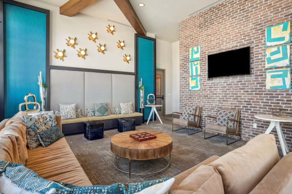 a living room with a brick wall and a couch and a coffee table