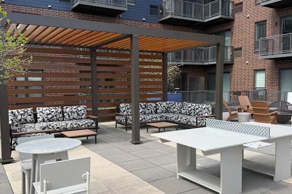 A patio with a white table and chairs.