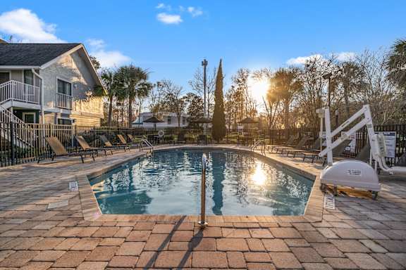 a swimming pool with a house in the background