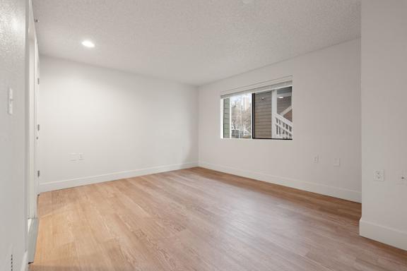 Empty room with wooden flooring and a window. at AVIA Lofts on Parkway, Vancouver, WA 98662