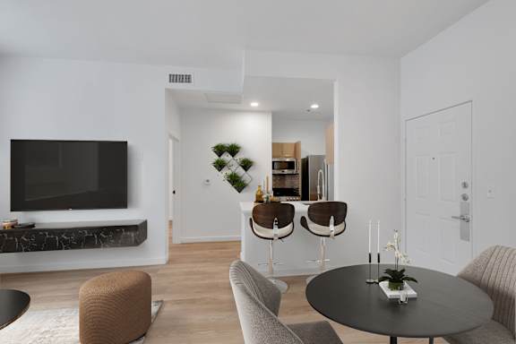 a living room with a table and chairs