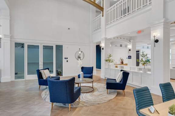 Comfortable chairs in lobby at AVIA Apartments On Alpha, Dallas, TX, 75240