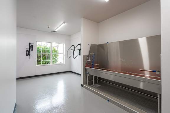 A clean, empty room with a stainless steel counter and a window. at AVIA Lofts on Victors Way, Michigan