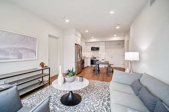 A modern living room with a grey couch and a coffee table.