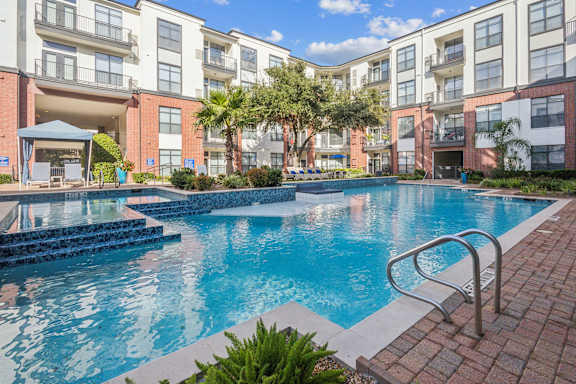 A swimming pool surrounded by apartment buildings.