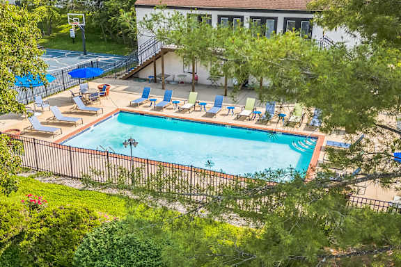 an aerial view of a house with a pool and tennis court