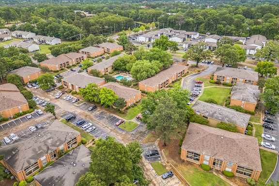 A bird's eye view of a residential area with houses and cars.
