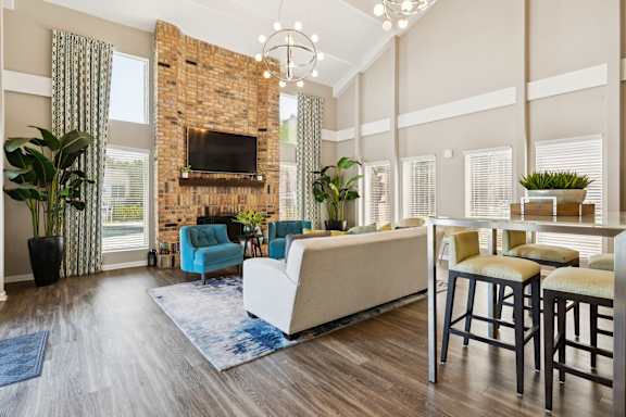 A living room with a fireplace and a blue chair.