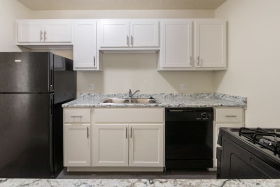 This is a photo of the kitchen of a 1245 square foot 2 bedroom apartment at Cambridge Court Apartments in Dallas, TX.