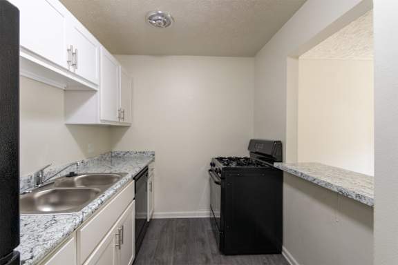 This is a photo of the kitchen of a 1245 square foot 2 bedroom apartment at Cambridge Court Apartments in Dallas, TX.